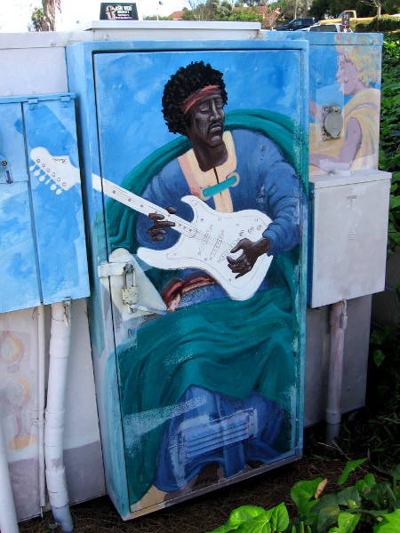 Jimi Hendrix plays electric guitar in heaven in colorful street art.