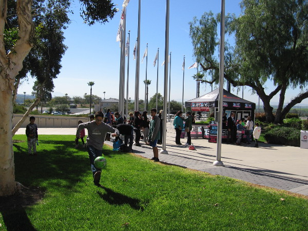 While the adults checked out event tents, kids were playing with soccer balls on the nearby grass. Perhaps some of these youth will one day be Olympic athletes!