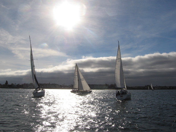 A magical look west toward sails, clouds and the descending sun.