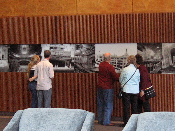 Visitors check out historical photos of the Fox Theatre movie palace on a wall near the San Diego Symphony box office.
