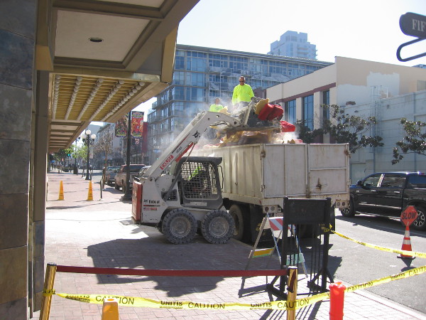 On a weekday morning, construction workers remove debris from the interior of the now vacant Gaslamp 15 movie theater.