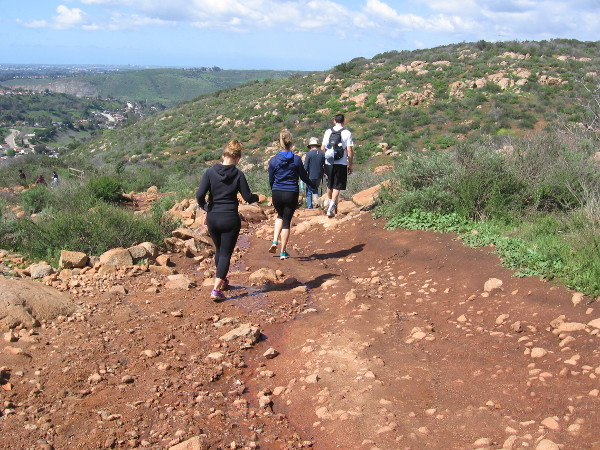 A group hikes up the trail.