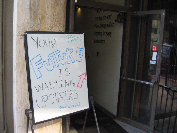 Sidewalk sign proclaims that your future is waiting upstairs!
