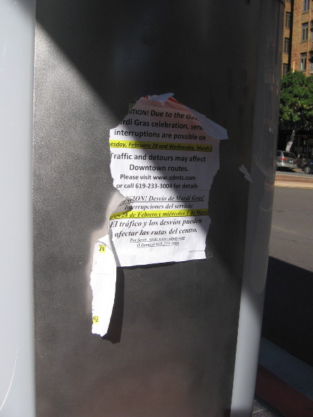 Torn sign at a Broadway bus station informs riders about yesterday's Mardi Gras detours.