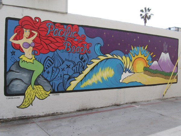 The Pacific Beach Mermaid hangs out on a colorful wall. Art by Jared Blake Lazar a.k.a Jared Black Lazer.