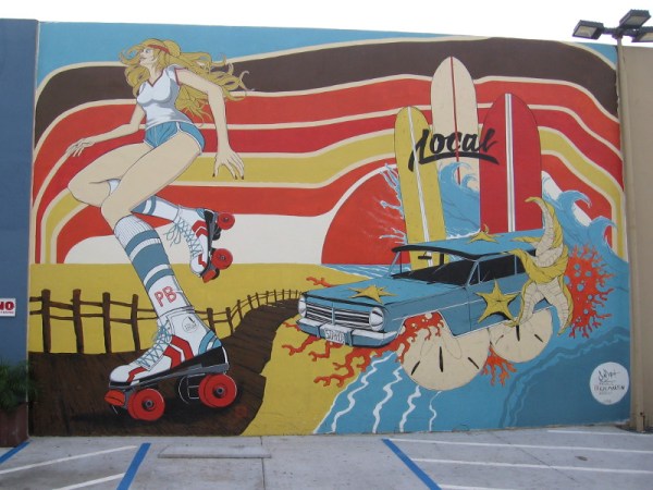 A cool mural near The Local Pacific Beach, painted in 2016 by artists Sean Dietrich and Kai Martin. A blonde on roller skates, the PB boardwalk, beach, and a very strange car.