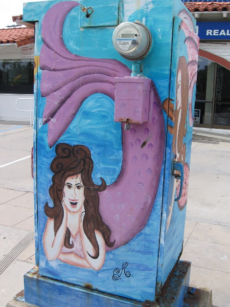 A friendly purple mermaid watches people driving down Mission Boulevard.