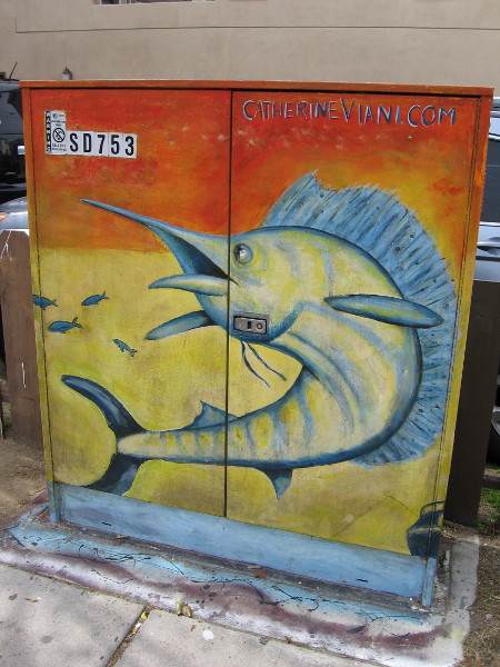 A sailfish swims above the sidewalk.