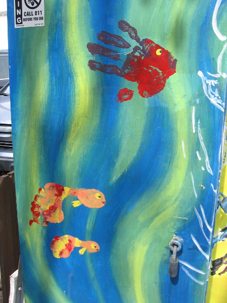 These fish in some kelp appear to be made of a hand and two feet dipped in paint!