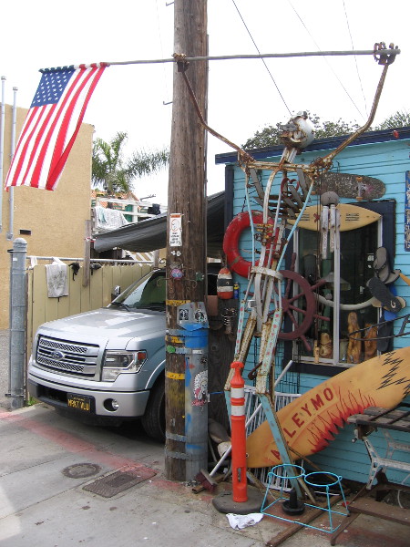The sculpture with American flag was created by Vinny after 911, who used scrap metal that he found discarded in the neighborhood.