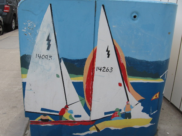 Two sailboats painted on an electrical box.