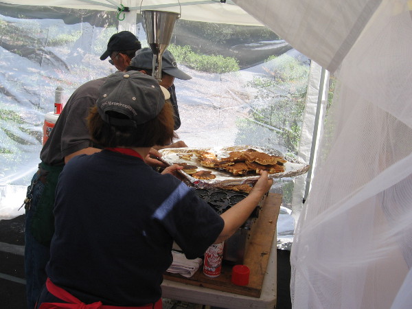 Preparing Taiyaki, Japanese fish-shaped cakes.