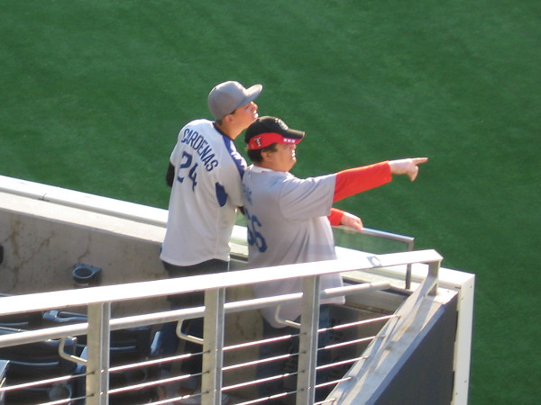 Fans at the World Baseball Classic in San Diego point to the outfield.