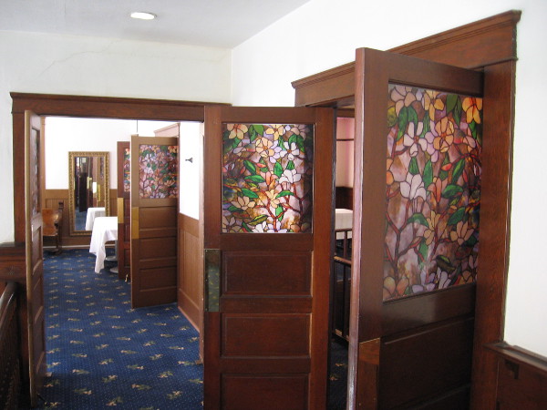 These doors on the second floor have beautiful floral stained glass panels.