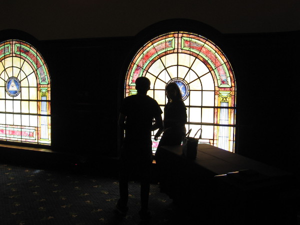 People pause by one of the south-facing stained glass windows.