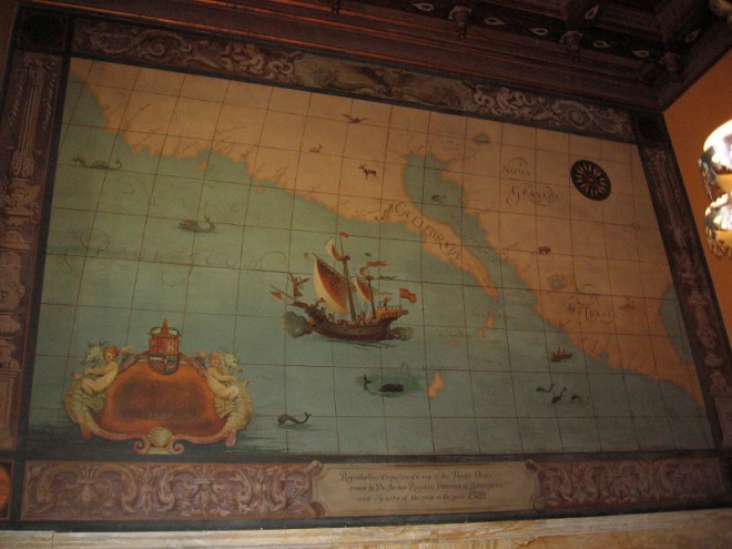 Map near the ceiling where steps descend to the elevators.