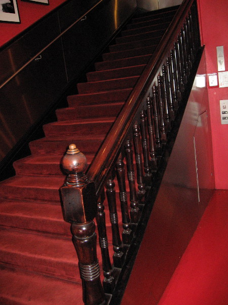 The original wooden banister leads up from the entrance of the Keating Building.