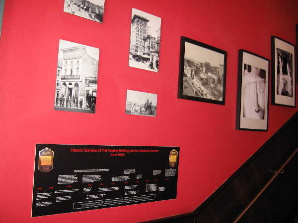 Historical photos on wall beside the lobby's staircase.