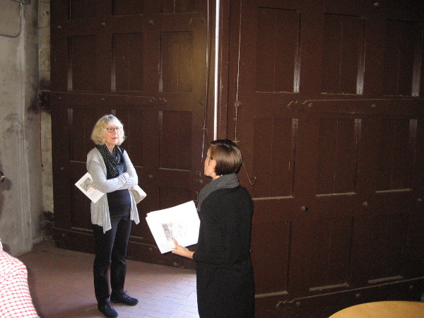 One of the enormous, heavy doors is opened from inside the historic building. I was told these were used for a railcar barn. Was coal for the power plant unloaded here? I don't know.