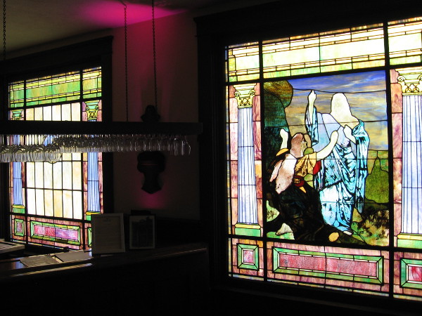Religious figures near wine glasses hanging in a bar on the second floor. An interesting juxtaposition.