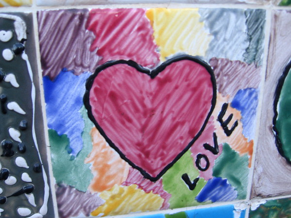 A red heart on patchwork colors. Love.