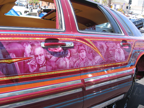 Cool graphics on the side of a customized lowrider on display at this year's Chicano Park Day Celebration. Many of the cars were fitted with hydraulic systems.