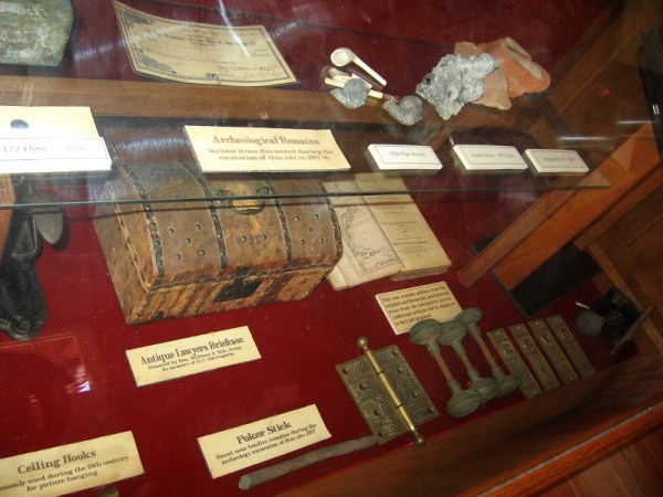 A display case in San Diego's first courthouse contains artifacts from the 19th century, including old pipe bowls and an antique lawyer's briefcase.