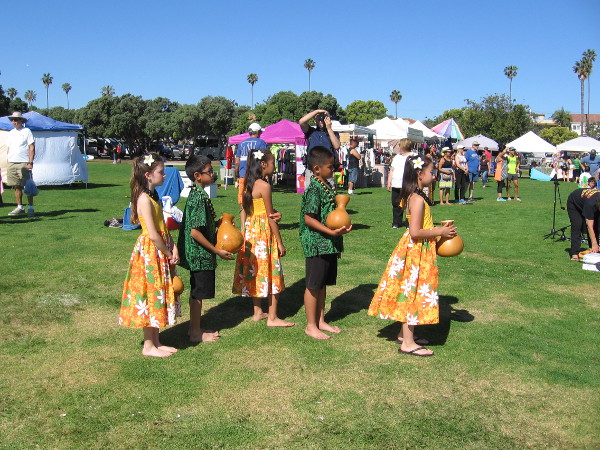 Youth prepare to take the stage. They hold ipu gourds, a traditional musical percussion instrument in Hawaii.