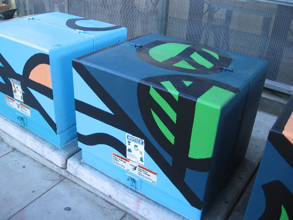 Boldly painted colors on a row of electrical boxes in Little Italy.