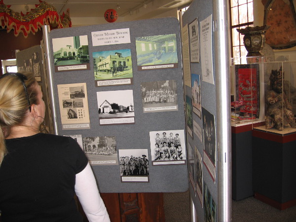 Someone looks at old photos of San Diego and Chinese residents who helped to build and grow our city.