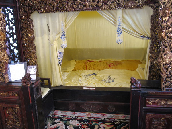 The gilt red-lacquered alcove bed, or babu chuang, was made of southern elm in the Sichuan province in the late 19th century.
