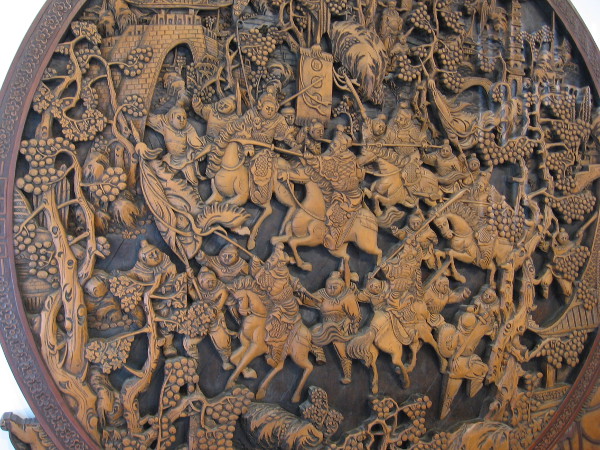 A scene from the Romance of the Three Kingdoms. The elaborate wood carving depicts the battle that Zhao Yun fought to save the sun of Liu Bei.