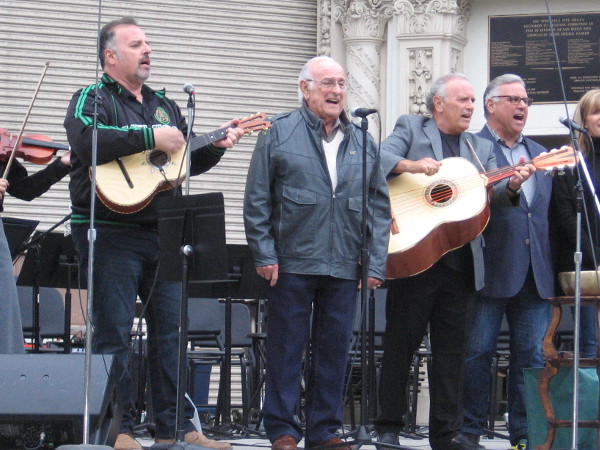The ageless Oscar Amezcua sings. The mariachi music full of vigor and joy.