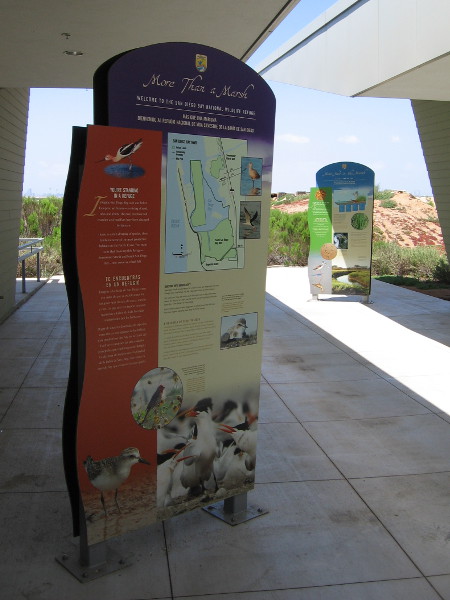 Large signs explain the role of a wildlife refuge.