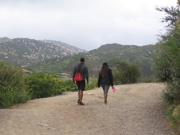 Hikers climb the Lake Poway Trail on an overcast weekend morning.