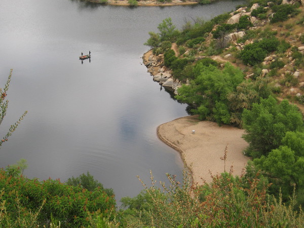 Several boats containing fishermen were floating on the lake below.