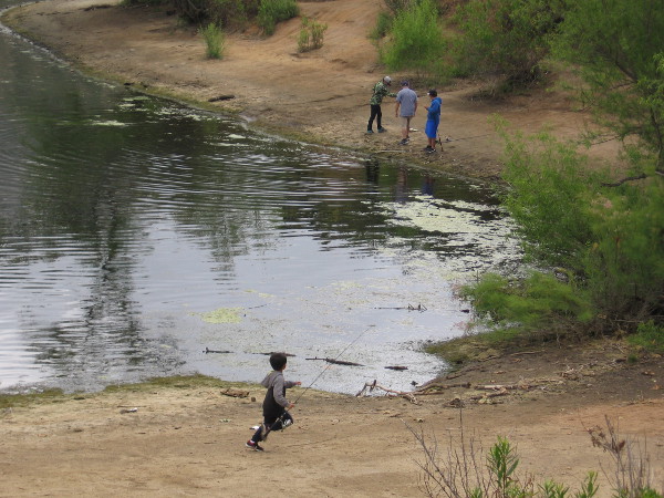 Someone caught a huge fish! One of the kids runs over to see!