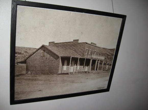 Photograph on the courtroom's back wall shows the Whaley House on the outskirts of tiny San Diego. It stands alone in barren place. It was built on a hanging ground not far from old El Campo Santo Cemetery.
