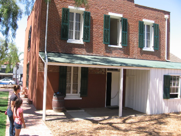 Photo of rear of Whaley House. The white detached room is the kitchen. In case of fire, the burning walls of the kitchen would be pulled away from the main building by horse.