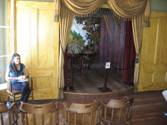 A docent explains the history of this first commercial theater in San Diego. The Tanner Troupe performed here from October 1868 to January 1869. The first performance reportedly attracted an audience of 150. The docent thought this number was improbable--for just one performance in this rather small room!