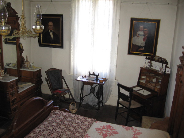 Photo of Thomas and Anna Whaley's master bedroom. According to the self-guided tour info, the walnut bedroom set is in the Renaissance Revival style. The writing desk was Anna's.
