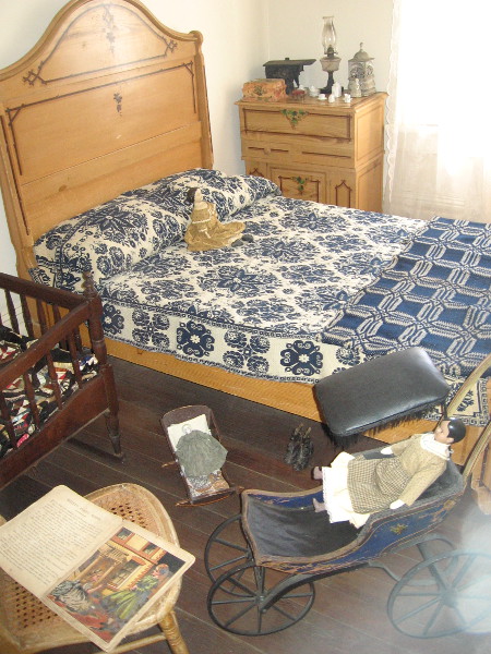 A visitor gazing into the children's bedroom said the dolls seemed very creepy. The crib just visible was used by four generations. An 18-month old Thomas Whaley Jr. died here from scarlet fever.