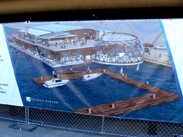 Graphic on a banner on the fence surrounding the old, closed Anthony's Fish Grotto. A new waterside dining experience is coming called Portside Pier.