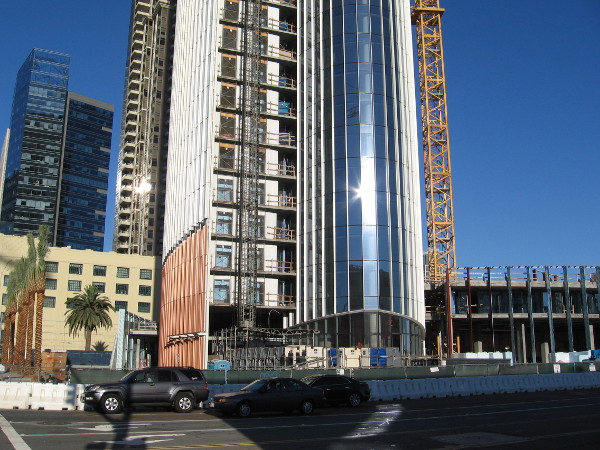 Construction continues near the base of Pacific Gate, a high-rise luxury condo. Photo taken from across Broadway.