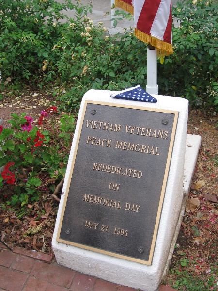 A folded flag above the plaque marking the Vietnam Veterans Peace Memorial in Balboa Park.