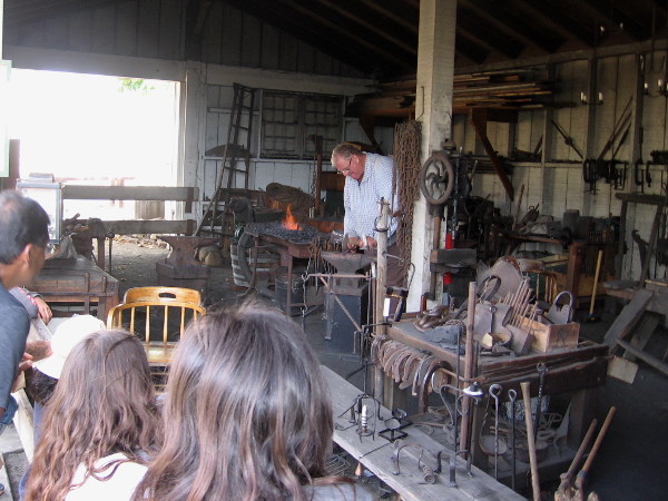 This friendly blacksmith provided lots of fascinating information. Visitors watch with interest as he works to create a pot holder.