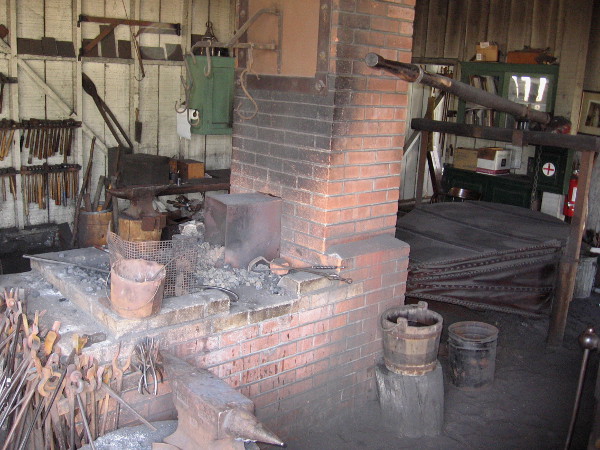 A huge bellows provides oxygen for this furnace. A good working temperature is about 1800 degrees Fahrenheit.