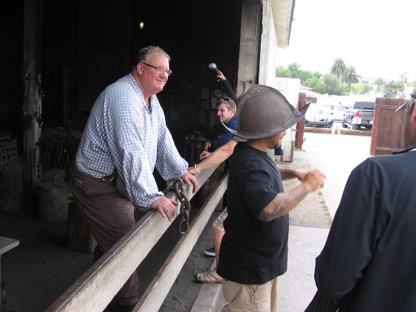 Old Town visitor tries on a Spanish conquistador helmet made in the Blacksmith Shop.