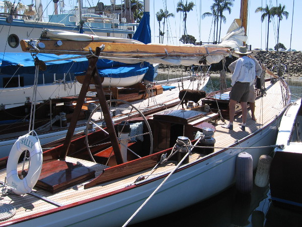 Some guys and a dog on the deck of Sally, of the San Diego Yacht Club.