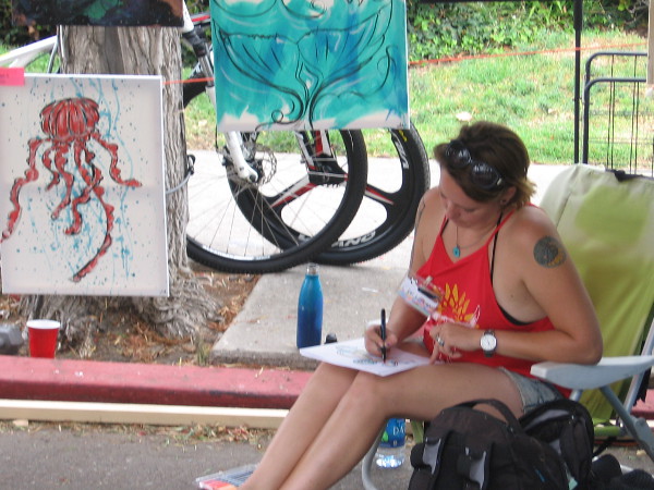 Another artist at the Ocean Beach Street Fair concentrates on her work.